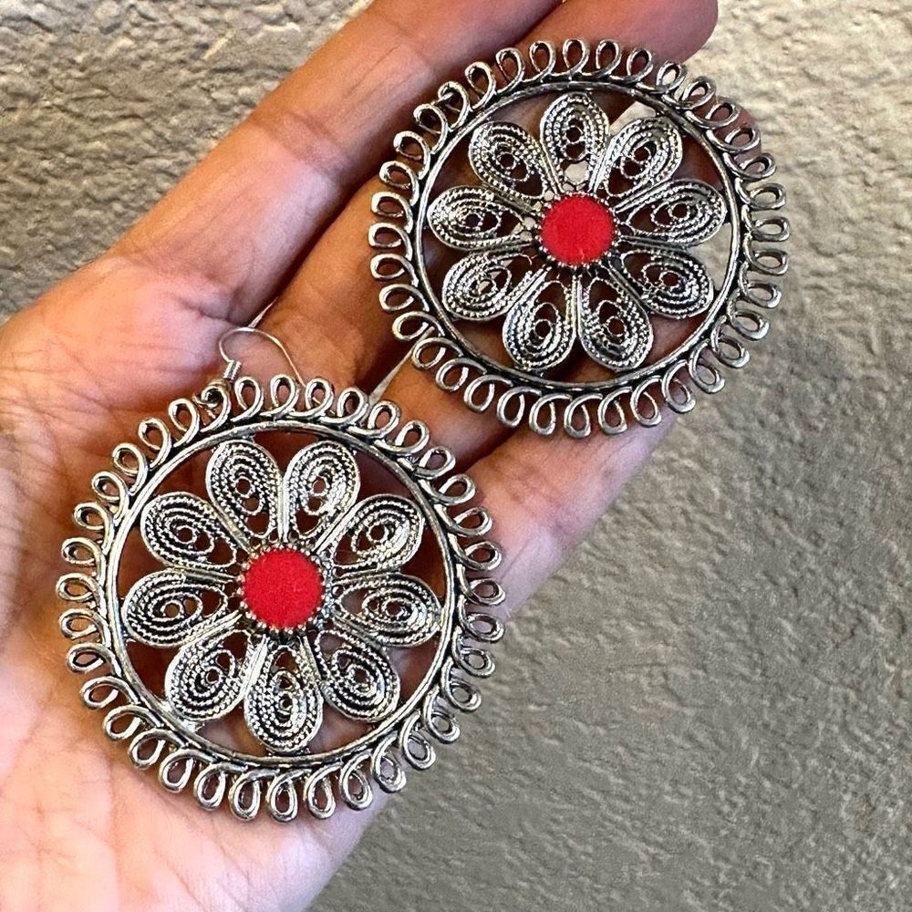 Silver tone and orange circle statement earrings